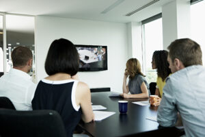 Group of people have a video conference call in a board room